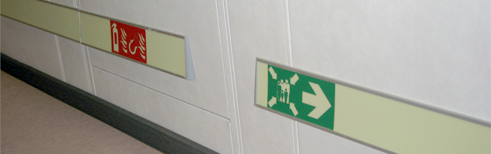 Safety symbols integrated in a photoluminescent low location lighting system.